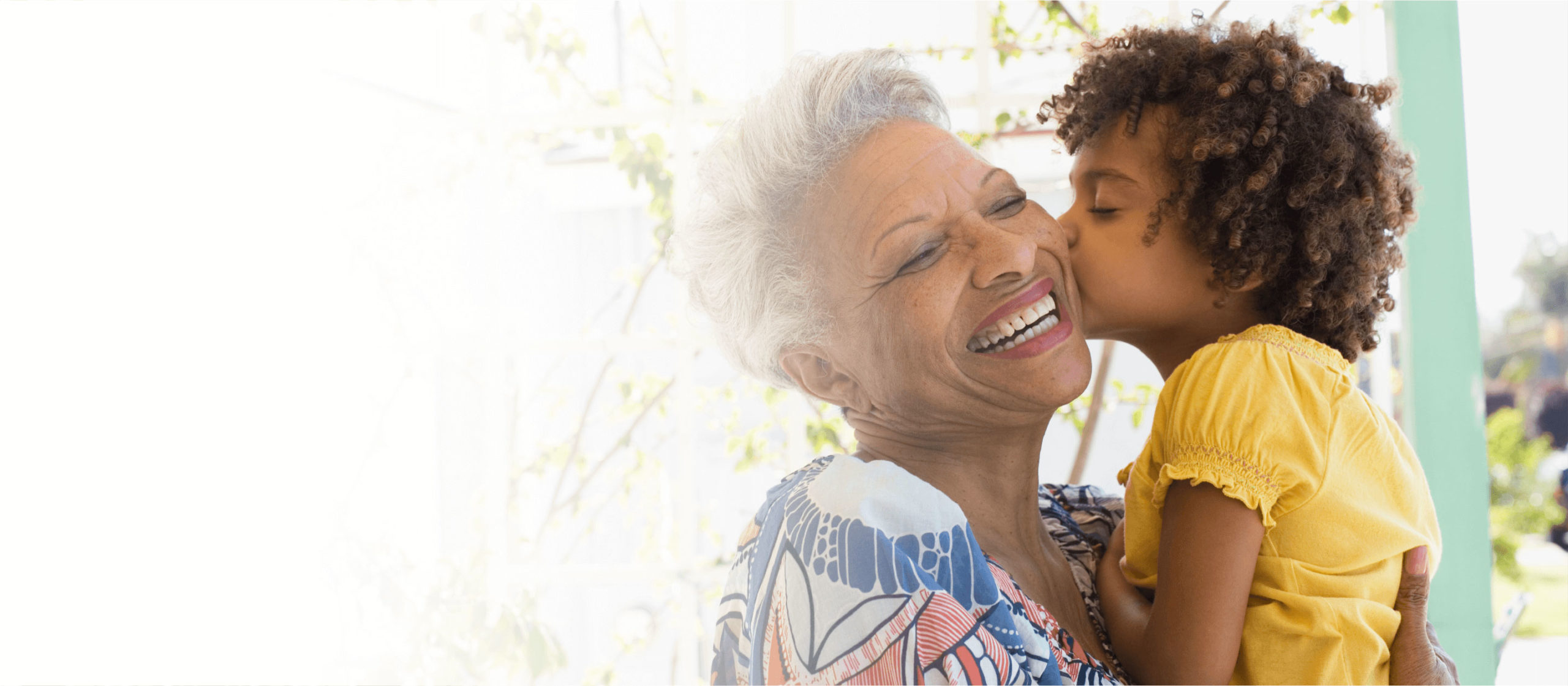 Grandchild kissing grandmothers cheek
